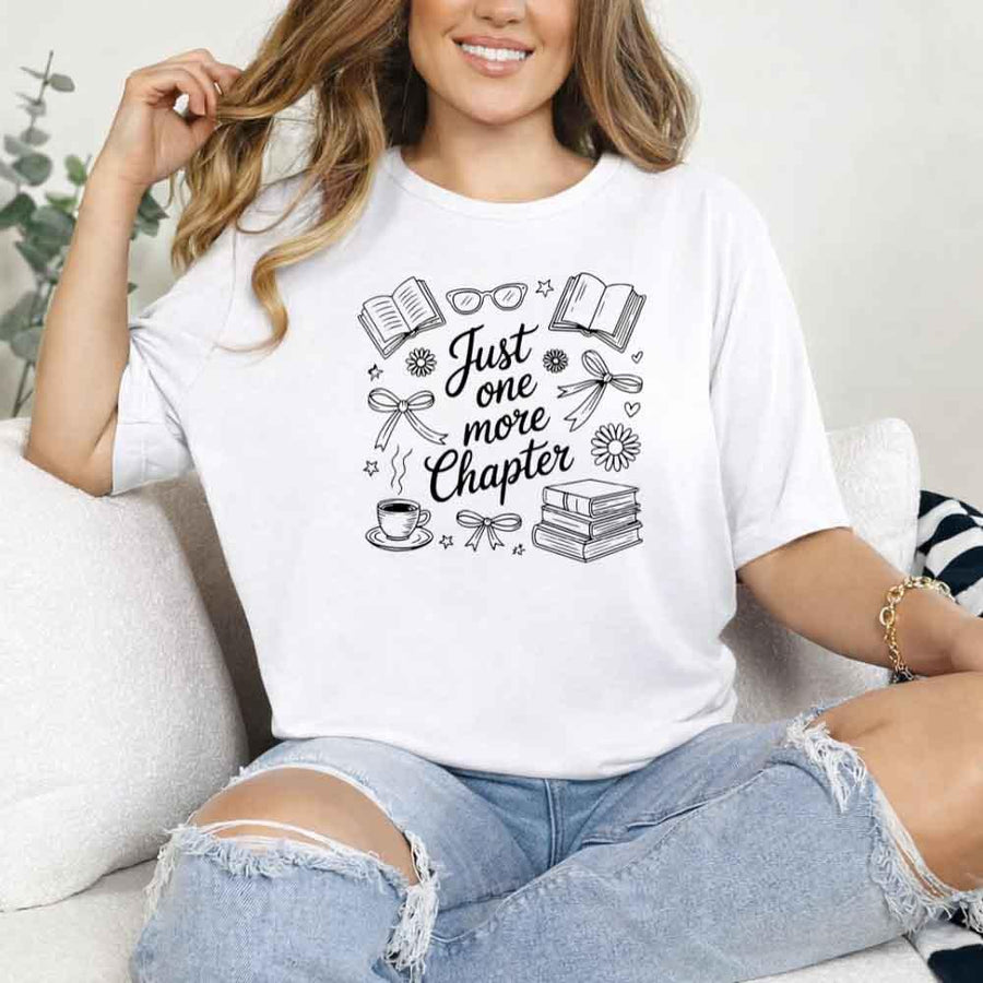 May include a person wearing a White Just One More Chapter T-Shirt featuring trendy book lover graphic and relaxed fit.