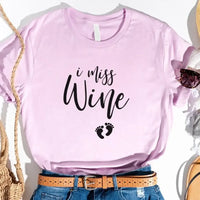 Lilac custom tee with 'I miss wine' text and baby footprints graphic, styled with jeans and belt
