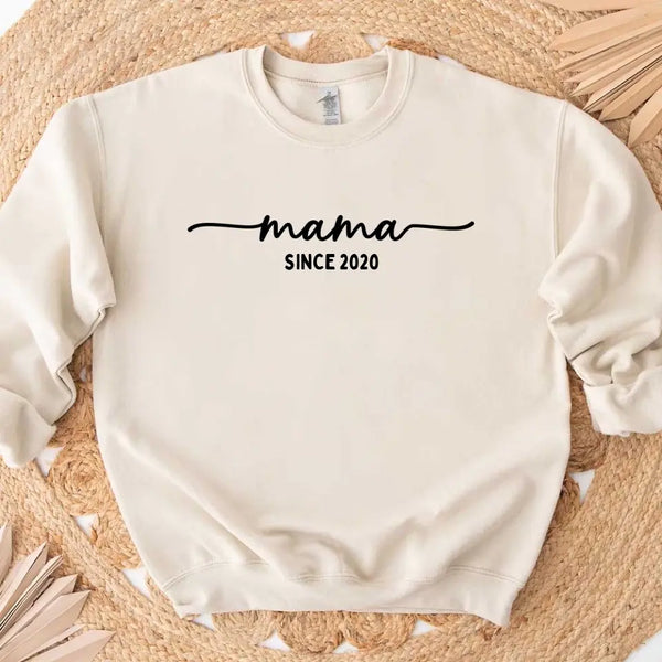 May include a personalized “Mama Since” shirt featuring minimalist lettering with a customizable year printed on the front.