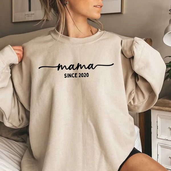 May include a personalized “Mama Since” shirt featuring minimalist lettering with a customizable year printed on the front.