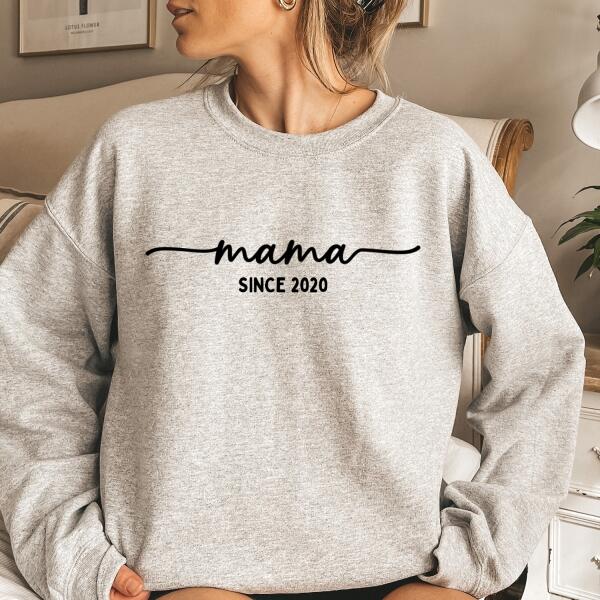 May include a personalized “Mama Since” shirt featuring minimalist lettering with a customizable year printed on the front.