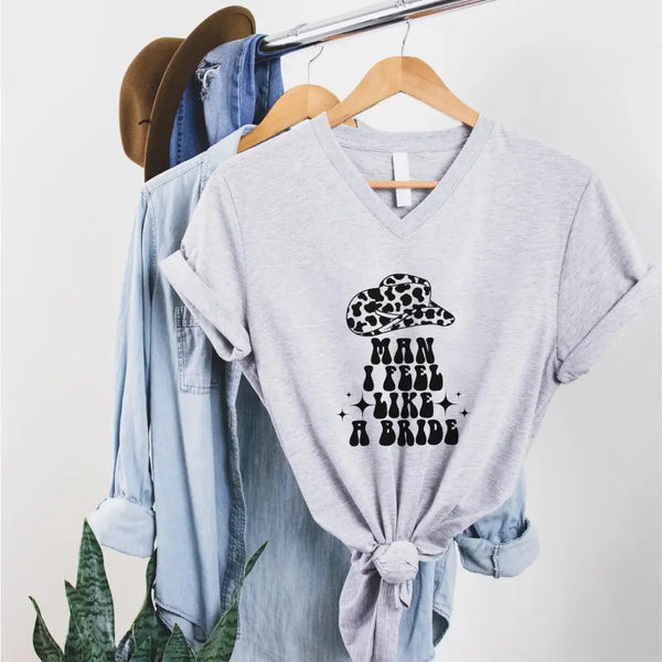 May include Sport Grey “Man I Feel Like a Bride” matching V-neck t-shirt for bachelorette party, bride squad country themed design.