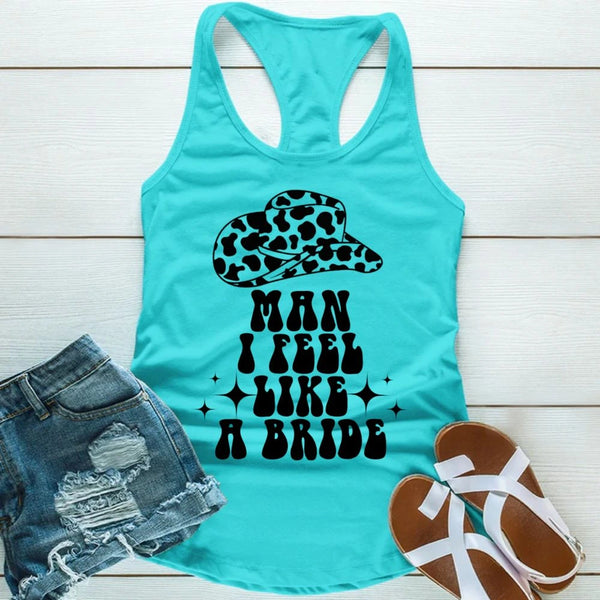 Turquoise tank top with leopard print hat graphic and text, paired with denim shorts and sandals on a light wooden surface.