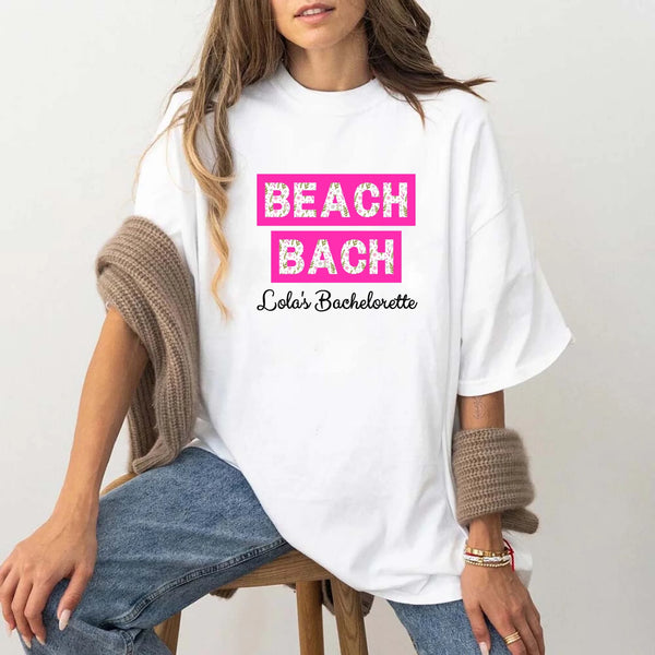 May include White personalized matching beach bridal shirts for bridesmaids, maid of honor, and bride, perfect for bachelorette parties and bridal showers.