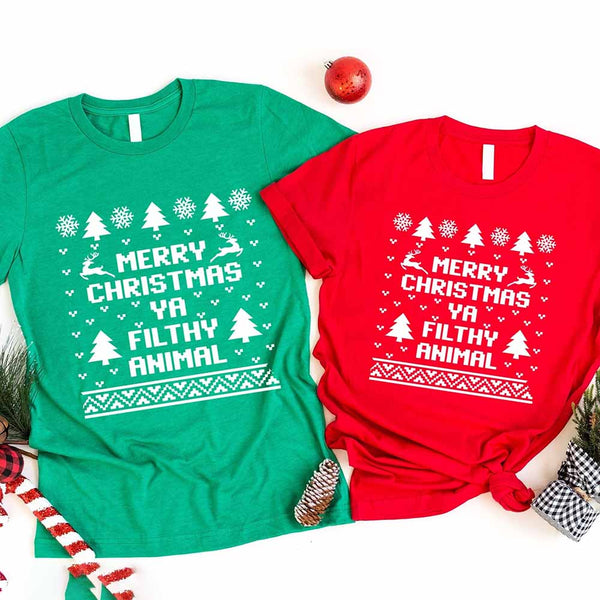 Green and red t-shirts with Christmas-themed text and graphics on a white background.