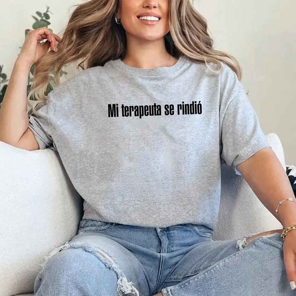 May include a person wearing a grey colored graphic t-shirt with the Spanish phrase “Mi Terapeuta Se Rindió”.