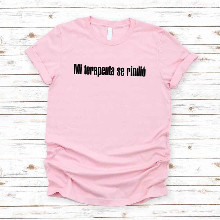 May include a person wearing a pink colored graphic t-shirt with the Spanish phrase “Mi Terapeuta Se Rindió”.