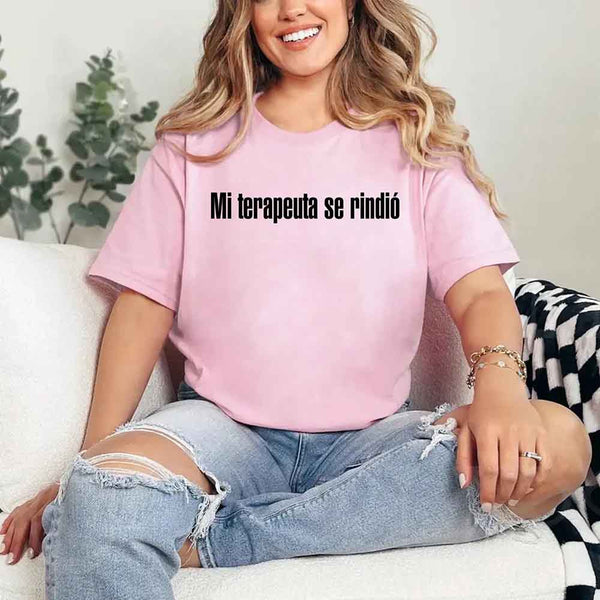 May include a person wearing a pink colored graphic t-shirt with the Spanish phrase “Mi Terapeuta Se Rindió”.