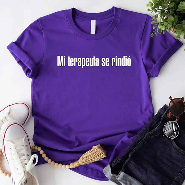 May include a person wearing a purple colored graphic t-shirt with the Spanish phrase “Mi Terapeuta Se Rindió”.