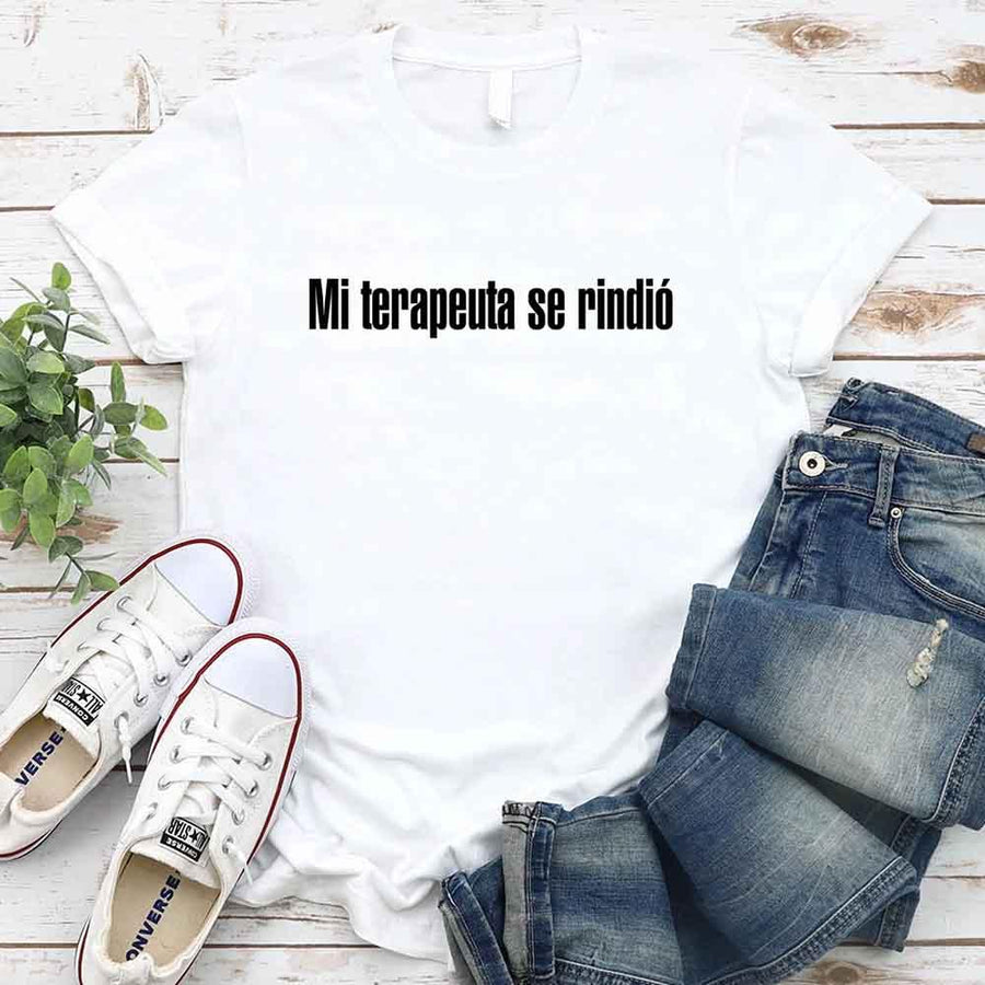 May include a person wearing a white colored graphic t-shirt with the Spanish phrase “Mi Terapeuta Se Rindió”.