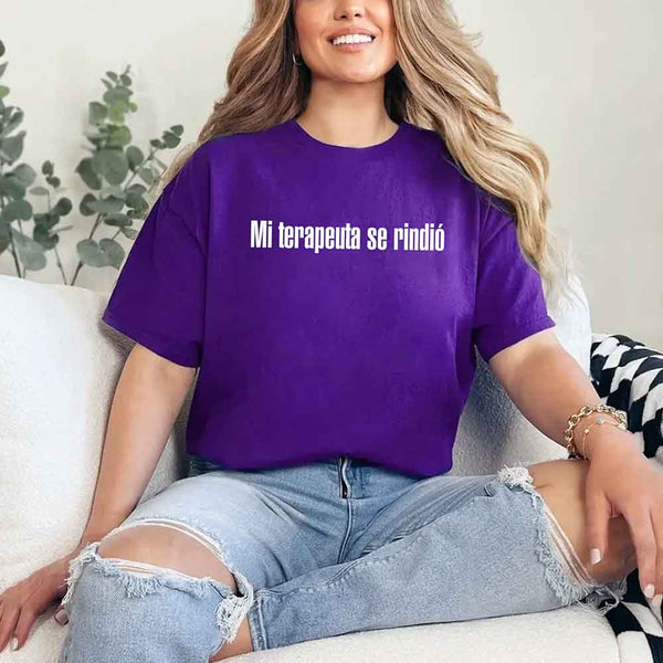 May include a person wearing a purple colored graphic t-shirt with the Spanish phrase “Mi Terapeuta Se Rindió”.