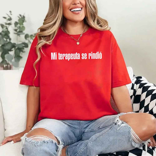 May include a person wearing a red colored graphic t-shirt with the Spanish phrase “Mi Terapeuta Se Rindió”.