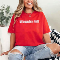 May include a person wearing a red colored graphic t-shirt with the Spanish phrase “Mi Terapeuta Se Rindió”.