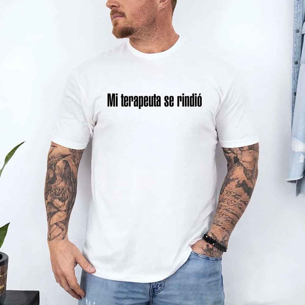 May include a person wearing a white colored graphic t-shirt with the Spanish phrase “Mi Terapeuta Se Rindió”.