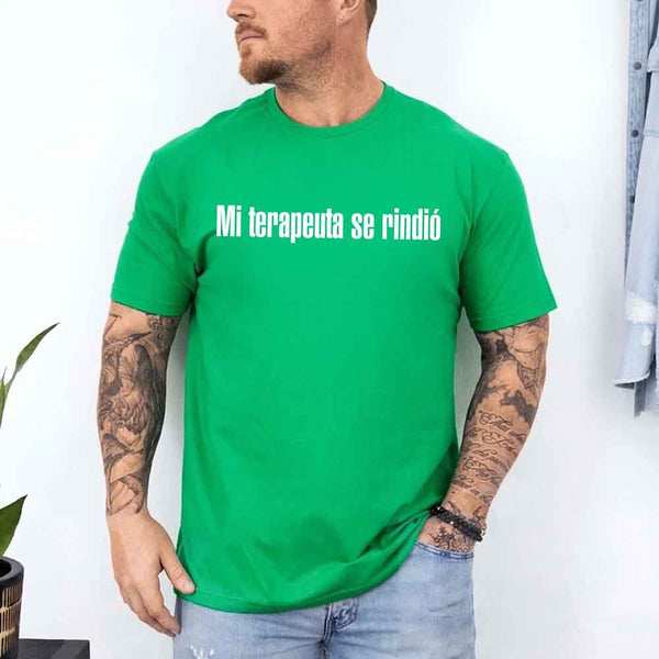 May include a person wearing a green colored graphic t-shirt with the Spanish phrase “Mi Terapeuta Se Rindió”.