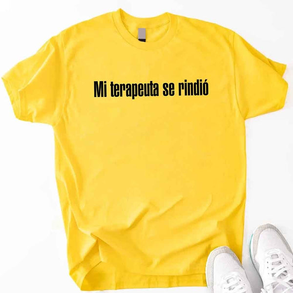 May include a person wearing a daisy colored graphic t-shirt with the Spanish phrase “Mi Terapeuta Se Rindió”.