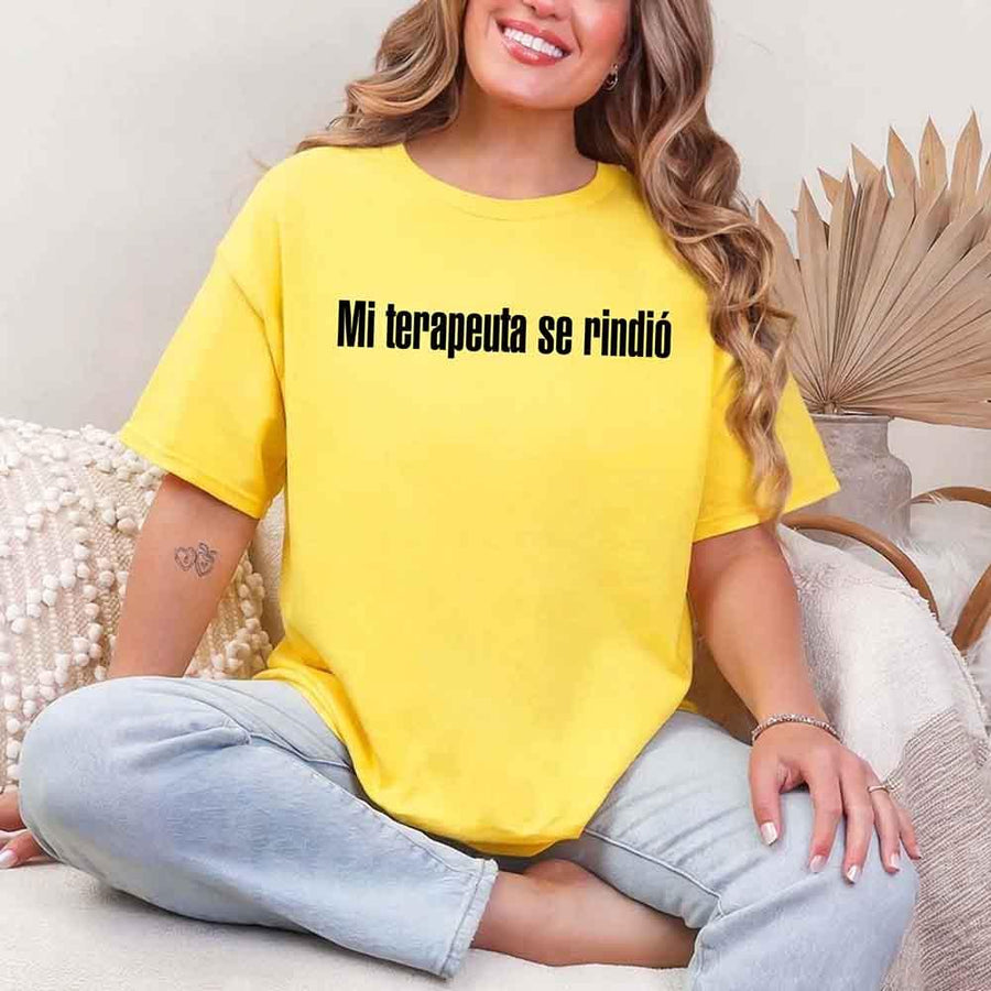 May include a person wearing a daisy colored graphic t-shirt with the Spanish phrase “Mi Terapeuta Se Rindió”.