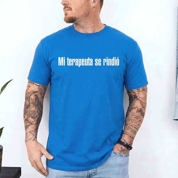 May include a person wearing a sapphire colored graphic t-shirt with the Spanish phrase “Mi Terapeuta Se Rindió”.