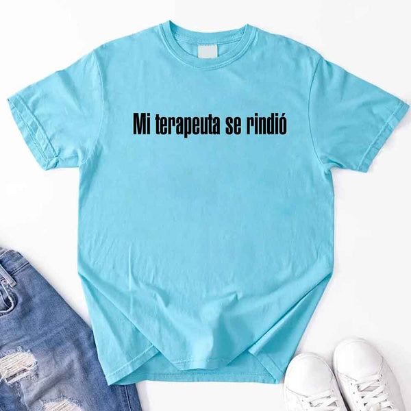 May include a person wearing a turqoise colored graphic t-shirt with the Spanish phrase “Mi Terapeuta Se Rindió”.