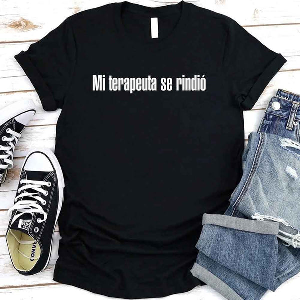 May include a person wearing a black colored graphic t-shirt with the Spanish phrase “Mi Terapeuta Se Rindió”.