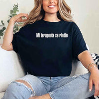 May include a person wearing a black colored graphic t-shirt with the Spanish phrase “Mi Terapeuta Se Rindió”.