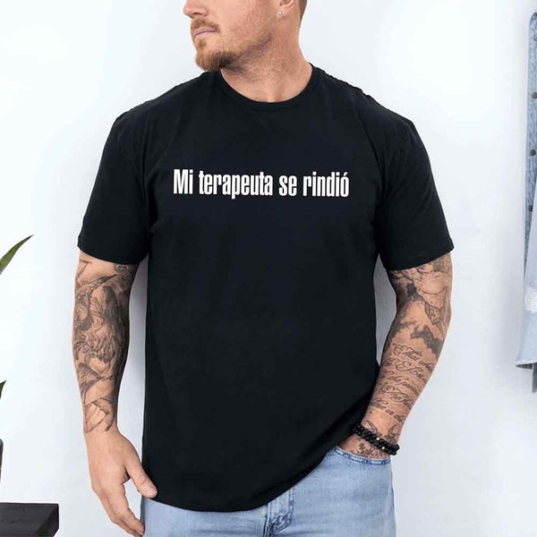 May include a person wearing a black colored graphic t-shirt with the Spanish phrase “Mi Terapeuta Se Rindió”.