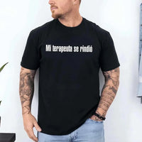 May include a person wearing a black colored graphic t-shirt with the Spanish phrase “Mi Terapeuta Se Rindió”.