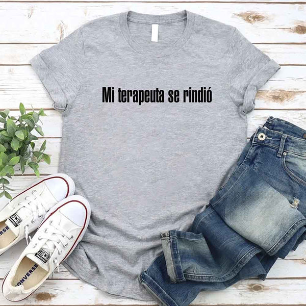 May include a person wearing a grey colored graphic t-shirt with the Spanish phrase “Mi Terapeuta Se Rindió”.