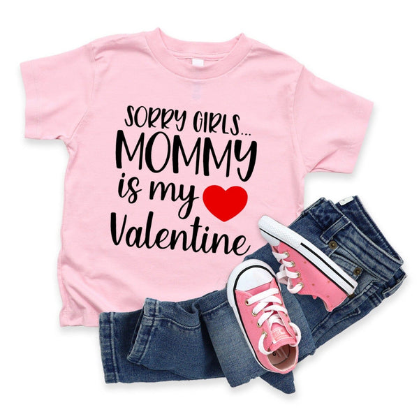 Pink t-shirt with 'Sorry girls... Mommy is my Valentine' text, pink sneakers, and blue jeans on a white background