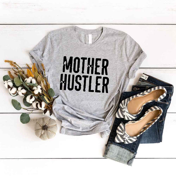 May include a unisex T-shirt with the Mother Hustler graphic displayed on the front in bold lettering.