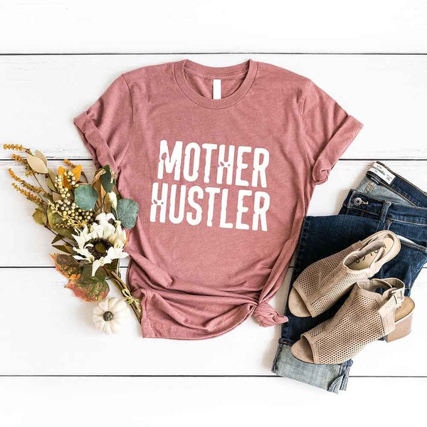 May include a unisex T-shirt with the Mother Hustler graphic displayed on the front in bold lettering.