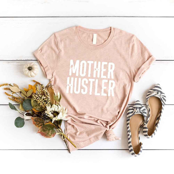 May include a unisex T-shirt with the Mother Hustler graphic displayed on the front in bold lettering.