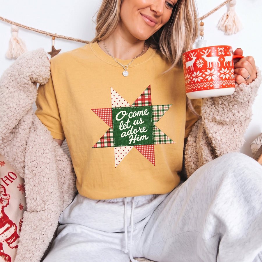May include an O Come Let Us Adore Him Comfort Colors Christmas T-Shirt featuring a Christian holiday message inspired by a beloved Christmas hymn, designed for church services, family gatherings, worship events, and meaningful seasonal gifting.