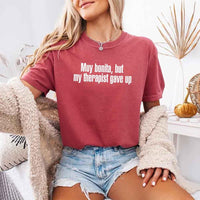 May include a person wearing a crimson colored sarcastic graphic t-shirt with the phrase “Muy Bonita But My Therapist Gave Up”.

