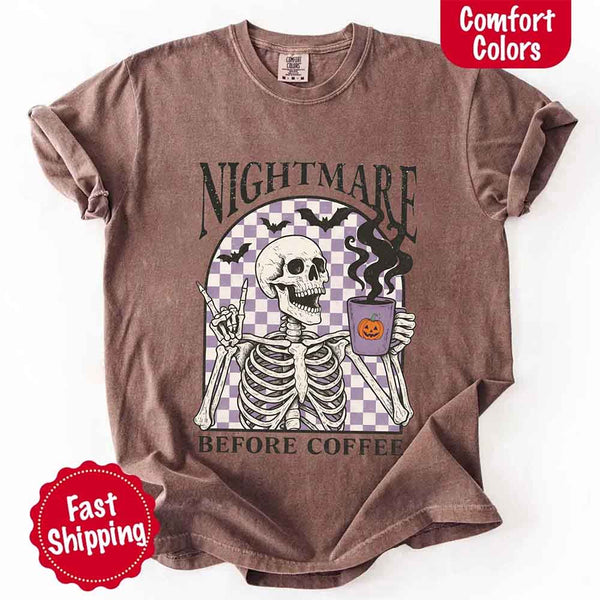 Nightmare Before Coffee skeleton graphic tee featuring skeleton holding a pumpkin coffee mug with steam, bats, and checkered background – funny Halloween coffee shirt.