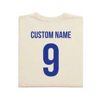 May include a person wearing a cream 2026 World Cup T-shirt featuring bold soccer graphic and relaxed fit.