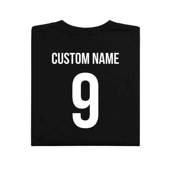 May include a person wearing a black 2026 World Cup T-shirt featuring bold soccer graphic and relaxed fit.