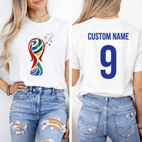 May include a person wearing a white 2026 World Cup T-shirt featuring bold soccer graphic and relaxed fit.