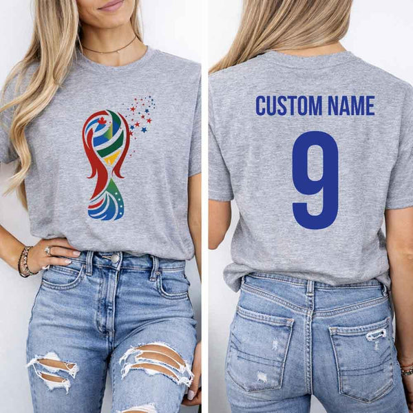 May include a person wearing a gray 2026 World Cup T-shirt featuring bold soccer graphic and relaxed fit.