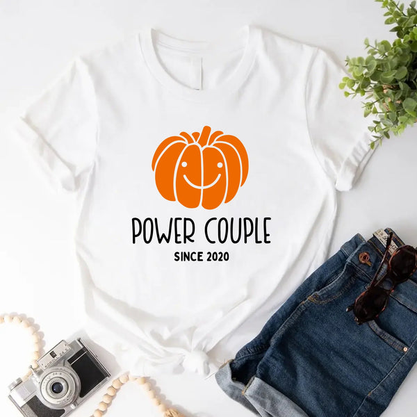 May include a fall-themed couple's design featuring a pumpkin graphic paired with a spice jar, personalized names, and a warm autumn color palette.