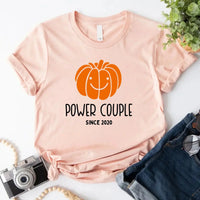 May include a fall-themed couple's design featuring a pumpkin graphic paired with a spice jar, personalized names, and a warm autumn color palette.