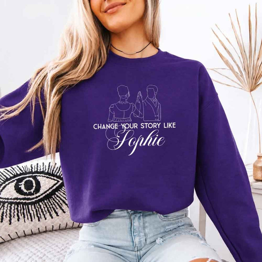 May include a person wearing a Purple Change Your Story Like Sophie Crewneck Sweatshirt featuring royal inspired graphic and classic fit.