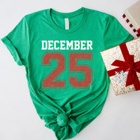 May include a retro-style Christmas sweatshirt featuring bold varsity lettering that reads “December 25” in green and red. The design has a vintage, slightly distressed look, giving it a nostalgic holiday feel perfect for festive winter wear.