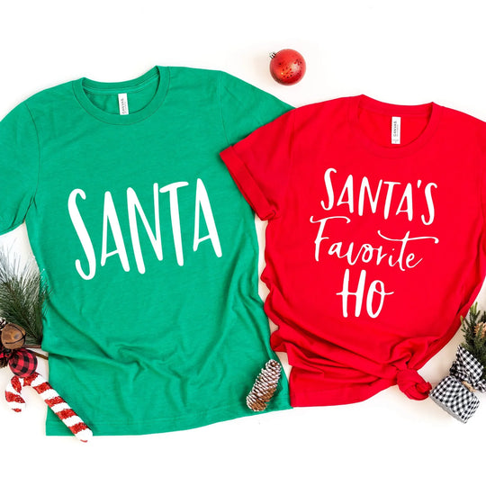 Two green and red t-shirts with text 'Santa's Favorite Ho's' and 'Ho Ho Ho' on them, displayed against a Christmas-themed background.