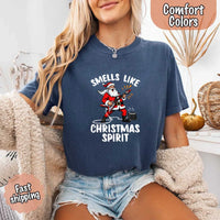 May include a Comfort Colors unisex t-shirt featuring a vintage-style Santa Claus graphic and the text “Smells Like Christmas Spirit” printed on soft cotton fabric.