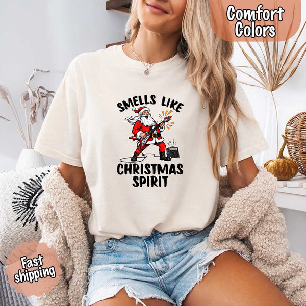 May include a Comfort Colors unisex t-shirt featuring a vintage-style Santa Claus graphic and the text “Smells Like Christmas Spirit” printed on soft cotton fabric.