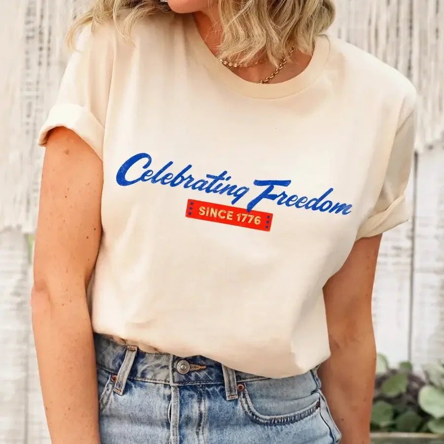 Person wearing a white t-shirt with 'Celebrating Freedom Since 1776' text.