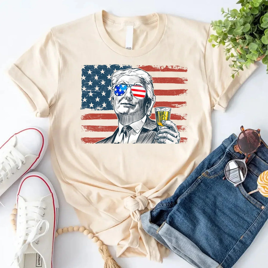Cream-color tee with American flag graphic and sketch of man.