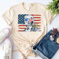Cream-color tee with American flag graphic and sketch of man.