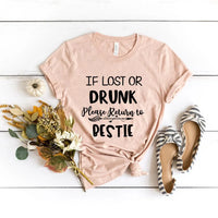Light Peach t-shirt with humorous text on a white wooden surface with flowers and shoes.